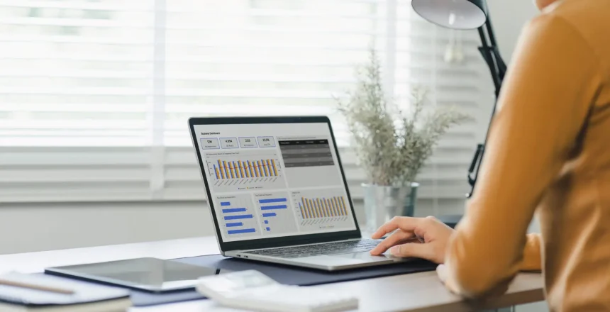 Female advisor financial business analytics using data dashboard graphs, charts, metrics, and KPI to analyze business performance