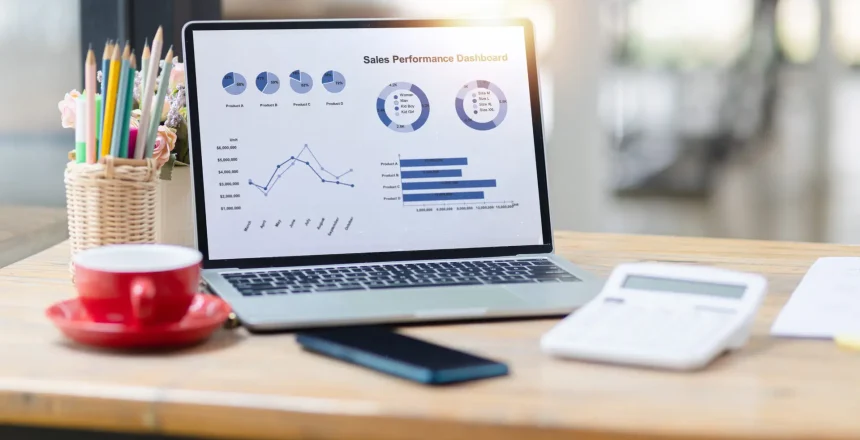 Laptop dashboard data analytics on office work desk, Stock market trends.
