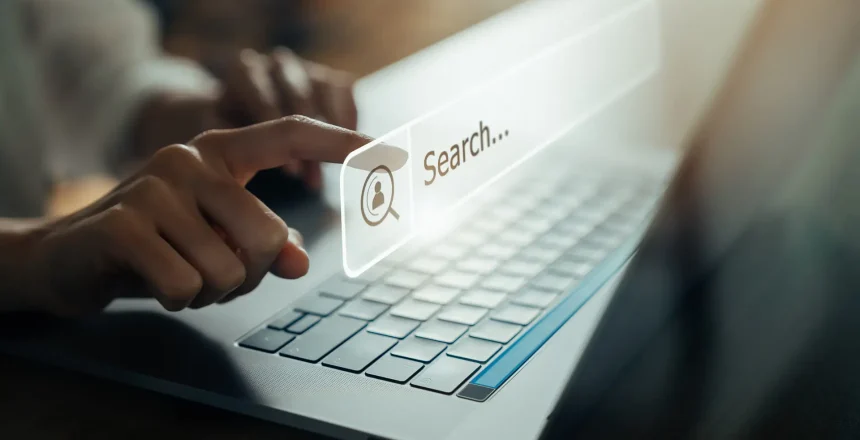 Hand using laptop and press screen to search Browsing on the Internet online.