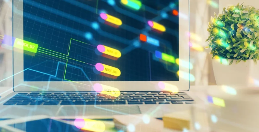 Laptop screen showing a neon data-flow diagram with labeled nodes and connecting lines on a dark grid.