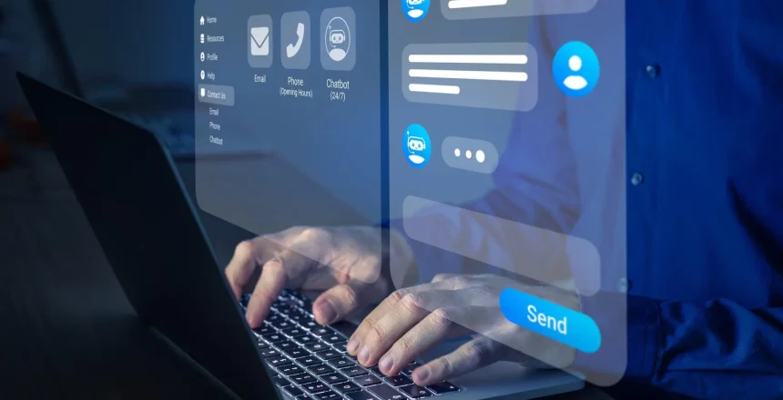 Hands typing on a laptop with translucent holographic chat UI panels and a large Send button.