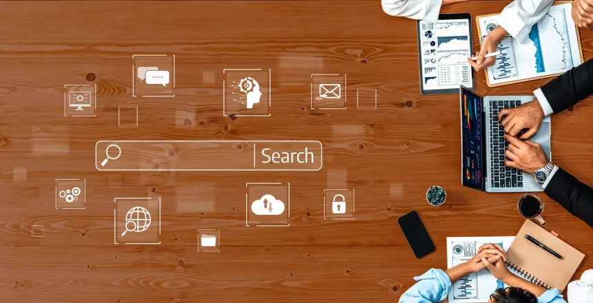 A dynamic office meeting scene showcasing collaboration among professionals, featuring laptops, data analytics, charts, and a digital search interface on a wooden table. Trope
